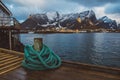 Spriral natical rope at a wooden pier on the background of mountains and landscapes on the islands Lofoten. Place for text or Royalty Free Stock Photo