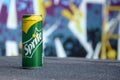 Sprite classic drink can on blurred colorful background outdoors