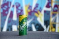 Sprite classic drink can on blurred colorful background outdoors