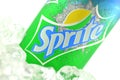 Sprite drink in a can on ice isolated on white background.