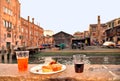 Spritz Aperol drink with venetian traditional snacks cicchetti on the water chanal background in Venice. Royalty Free Stock Photo