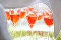 Spritz Veneziano with orange aperol prepared in champagne glasses covered with a napkin as an aperitif for a festive reception,