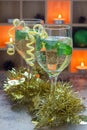 Spritzer cocktail with white wine, mint and ice, decorated with spiral lemon zest