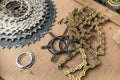 A sprocket cassette, chain, cog lock ring, spider and other components of a mountain bike drivetrain lying on a piece of cardboard Royalty Free Stock Photo