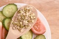 Sprouted beans. Tomato and cucumber. Fresh salad. Wooden spoon