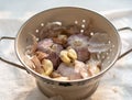 sprouted garlic placed in a bowl. many peeled and unpeeled garlics are together.