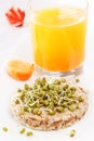 Sprouted grains on puffed wheat cakef, fresh juice, carrots. Healthy food from natural products Royalty Free Stock Photo