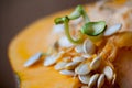 Sprouting pumpkin seeds and fibrous strands within cut pumpkin. Close-up