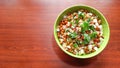 Sprouts salad with green coriander in a green bowl on wooden table Royalty Free Stock Photo