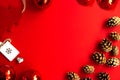 Spruce cones, red Christmas balls, Christmas tree decoration on a bright red background Royalty Free Stock Photo