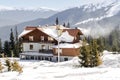 spruce pine trees and old wooden village rural house in snow in winter forest in mountains,nature. Royalty Free Stock Photo