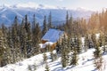 spruce pine trees and retro wooden village rural house in snow in winter forest in mountains,. Royalty Free Stock Photo