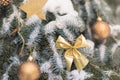 Spruce in the snow decorated with golden Christmas balls and stars. Holiday concept Royalty Free Stock Photo