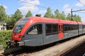 Spurt train in red and black of R-NET on Merwedelingelijn along platform at station Dordrecht