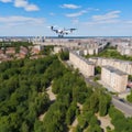 Spy drone weapon flying under city. Military technology, buildings, civilian town, blue summer sky