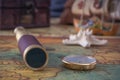 Spyglass, a brass compass and a starfish lie on an old map against the background of a wooden model of a sailboat. Royalty Free Stock Photo