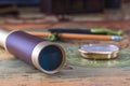 Spyglass, compass and a pencil with a measuring instrument lie on an old map. Royalty Free Stock Photo