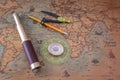 Spyglass, compass and a pencil with a measuring instrument lie on an old map. Royalty Free Stock Photo