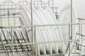 Dishes in basket of dishwasher household equipment closed up Royalty Free Stock Photo