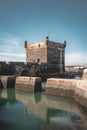 Sqala du Port, a defensive tower at the fishing port of Essaouira, Morocco near Marrakech. Blue sky with clouds and Royalty Free Stock Photo