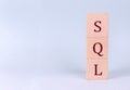 SQL - Structured Query Language on wooden cubes on a blue background