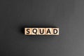 Squad - word from wooden blocks with letters