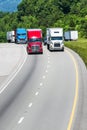 Squadron of Heavy Trucks On Interstate With Copy Space Royalty Free Stock Photo