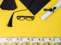 Square academic cap and money on yellow Royalty Free Stock Photo