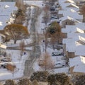 Square Aerial view of Utah Valley neighborhood with homes and roads on snowy winter day Royalty Free Stock Photo