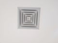 Box-shaped air vents with a layered design in the center of the room\'s ceiling Royalty Free Stock Photo