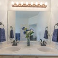 Square Alcove double vanity sinks with flower vase on a marble countertop