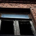 Square background with a broken window in a brick building Royalty Free Stock Photo