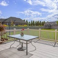 Square Balcony with view of the spacious yard under cloudy blue sky on a sunny day