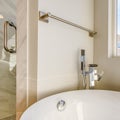 Square Bathtub and separated shower inside the bathroom with towel rod on the wall