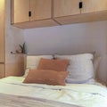 Square Bedroom interior of home with built in cabinets over and on both sides of bed