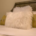 Square Bedroom interior with pillows against upholstered belgrave headboard of a bed