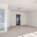 Square Bedroom with lots of lighting coming in from the windows