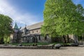 A square with benches and flower beds next to scenic Stavanger Cathedral at city downtown early morning on Constitution Day