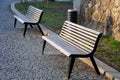 Square with benches with wood paneling on the square and in the street. metal frames are black and waste bins made of plastic knur Royalty Free Stock Photo