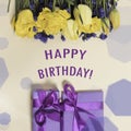 Square birthday greeting card happy birthday with yellow tulip flowers and purple gift boxes. Royalty Free Stock Photo