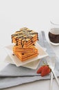 Square biscuits cracker with strawberry jam homemade.it is stacked on white plate and topping chocolate.