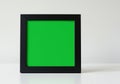 Square black frame with a solid green background, possibly a chroma key, set against a Royalty Free Stock Photo