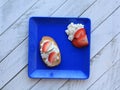 Square blue plate with brucshetta  with cheese and strawberries Royalty Free Stock Photo