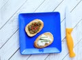 Square blue plate and knife with brucshetta with cheese and pesto. Royalty Free Stock Photo