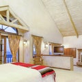 Square Bright, open and warm master bedroom with vaulted ceilings and a fireplace Royalty Free Stock Photo