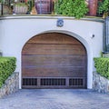 Square Brown arched wood door of garage under luxurious house in San Diego California Royalty Free Stock Photo