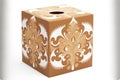 square brown tissue box with white lucky ornament on white background