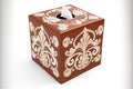 square brown tissue box with white lucky ornament on white background