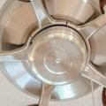 Square Ceiling fan with wooden blades and lights mounted on the ceiling of a home