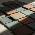 Square ceramic tiles in shades of brown, green, and blue are arranged in a grid Royalty Free Stock Photo